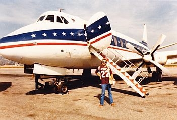 Jimmy Buffett standing in front of his Viscount touring aircraft in the early 80s